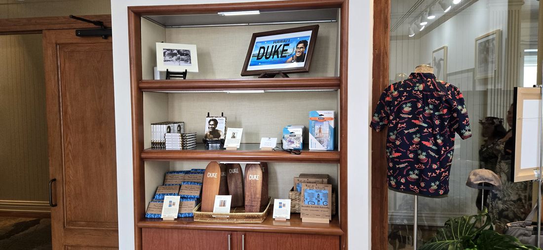 Wooden shelves of books, boards and keepsakes.