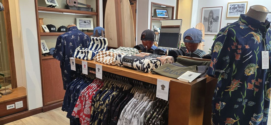 Aloha shirts on the rail and on a form in the middle of the room.
